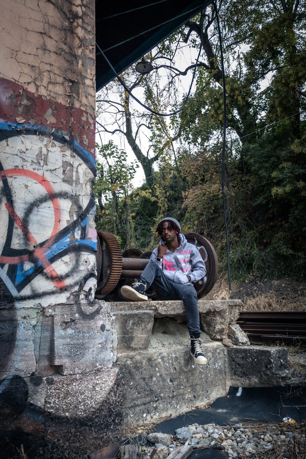 CENSORED CLOTHIN campaign — grey hoodie under the bridge